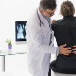 Physical Doctor consulting with patient about Back problems Physical therapy