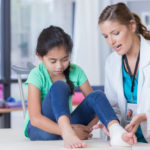 Doctor examining child's foot