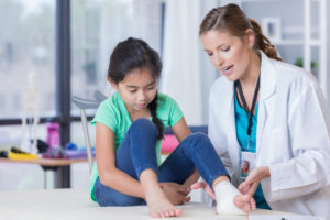 Doctor examining child's foot