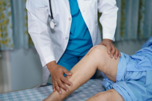 Doctor checking the patient after total joint replacement surgery