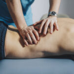 Physical Therapist Giving massage for lower back pain