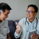 Image of Asian doctor visit home of a senior man patient and giving medical consultation