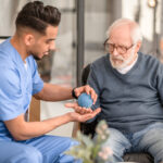 Concentrated physiatrist conducting a physiotherapy session
